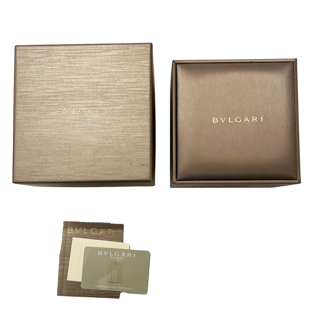 Top down view of BVLGARI Lvcea Tubogas watch packaging showing outer box, inner case, and international warranty card on white background
