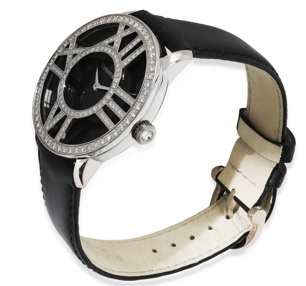 Angled view of Tiffany & Co. Atlas unisex watch in 18kt white gold with diamond-set Roman numeral openwork bezel and black leather strap