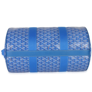 Top-down view of Goyard Barrel 40 sports bag in sky blue showing Goyardine chevron pattern and central leather strap on white background