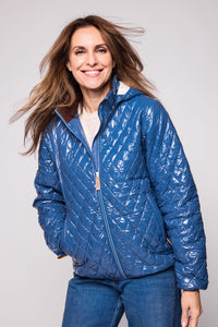 Women's shiny blue puffer jacket for fall and winter with removable hood, insulated lining, and water-resistant outer shell