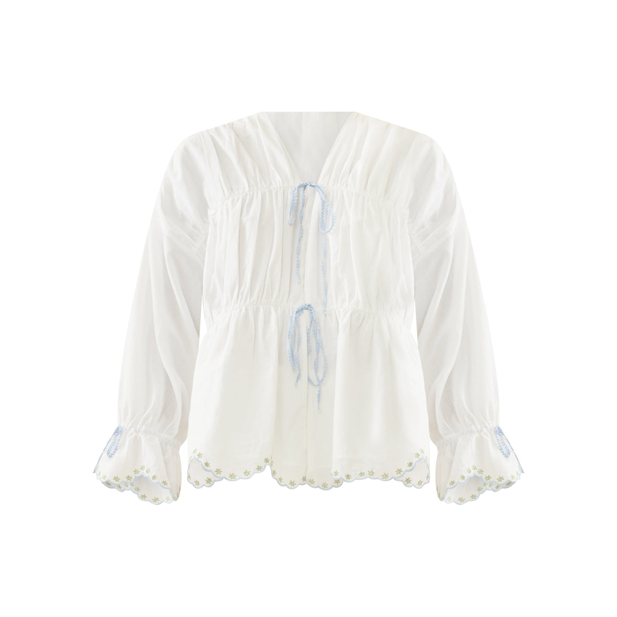 Front view of Isle top in White Whimsy with V-neck, two blue tie closures, peplum waist, puff sleeves, scalloped embroidered hem