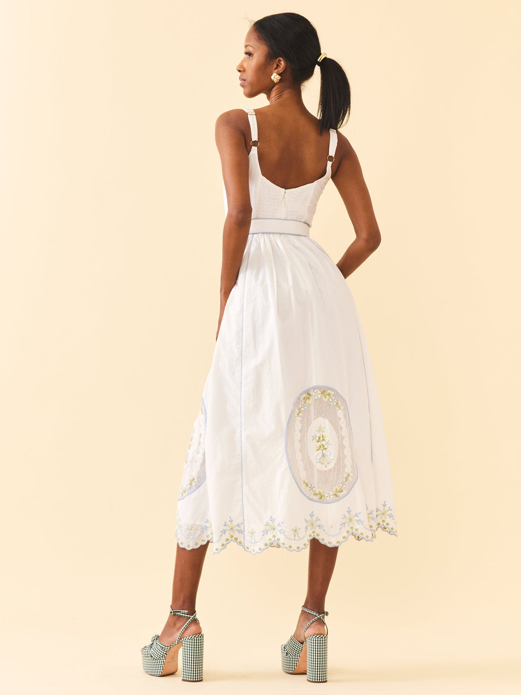 Back view of Katherine Dress in White Whimsy showing smocked back, adjustable straps and embroidered A-line skirt