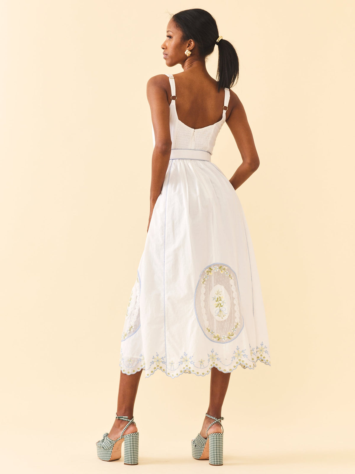 Back view of Katherine Dress in White Whimsy showing smocked back, adjustable straps and embroidered A-line skirt