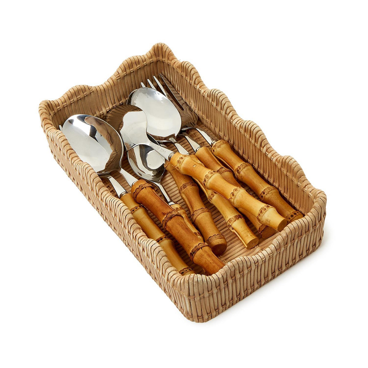 Angled top view of scalloped-edge woven utensil holder holding bamboo-handled serving utensils on white background