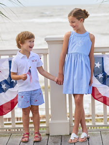 Little English traditional children's clothing.  Blue gingham shorts with all-over American flag embroidery for boys.  Boy's shorts for 4th of July.
