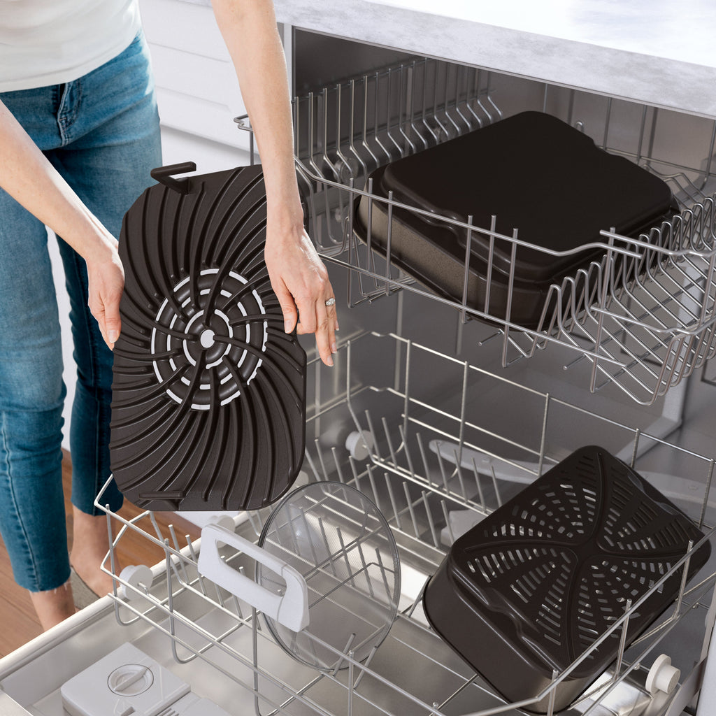 Close-up of Foodi Smart XL indoor grill and air fryer removable grill plates being placed in a dishwasher to show dishwasher-safe parts