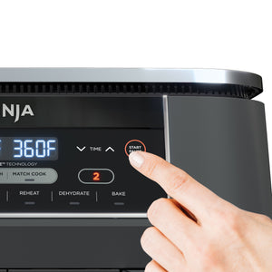 Close-up of Foodi 6-in-1 8qt air fryer control panel with finger on Start Pause button and display reading 360F