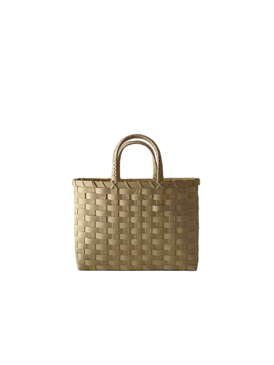 Woven basket with handles on a plain background