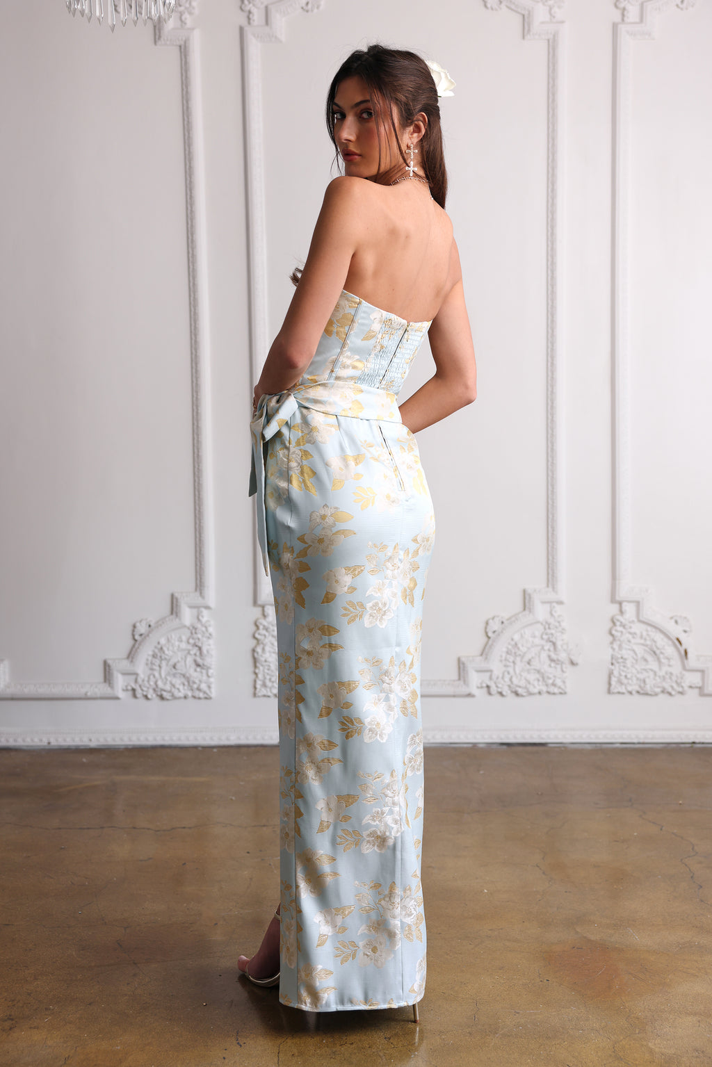 Rear view of June Dress in Ballad Blue Baroque Floral showing strapless corset back, side tie waist, and long skirt