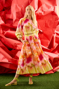 A pleated full skirt in a colorful print with a matching long sleeve top
