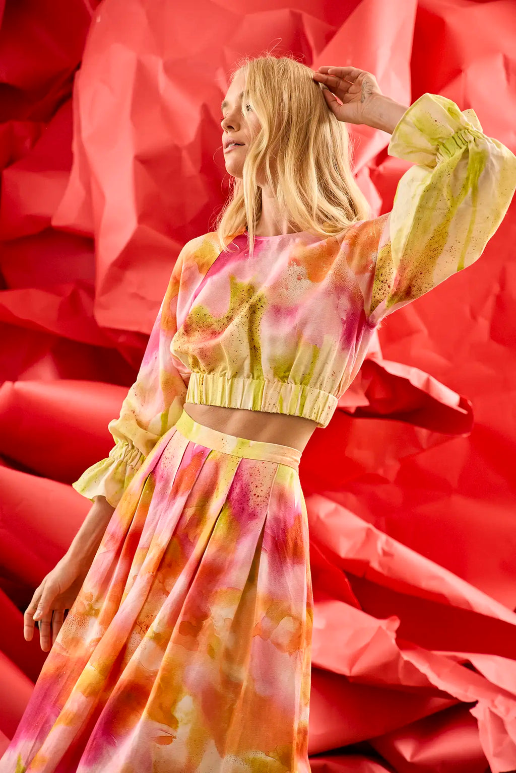 Cropped long sleeve top in yellow and pink tie-dye print with elastic at the sleeves