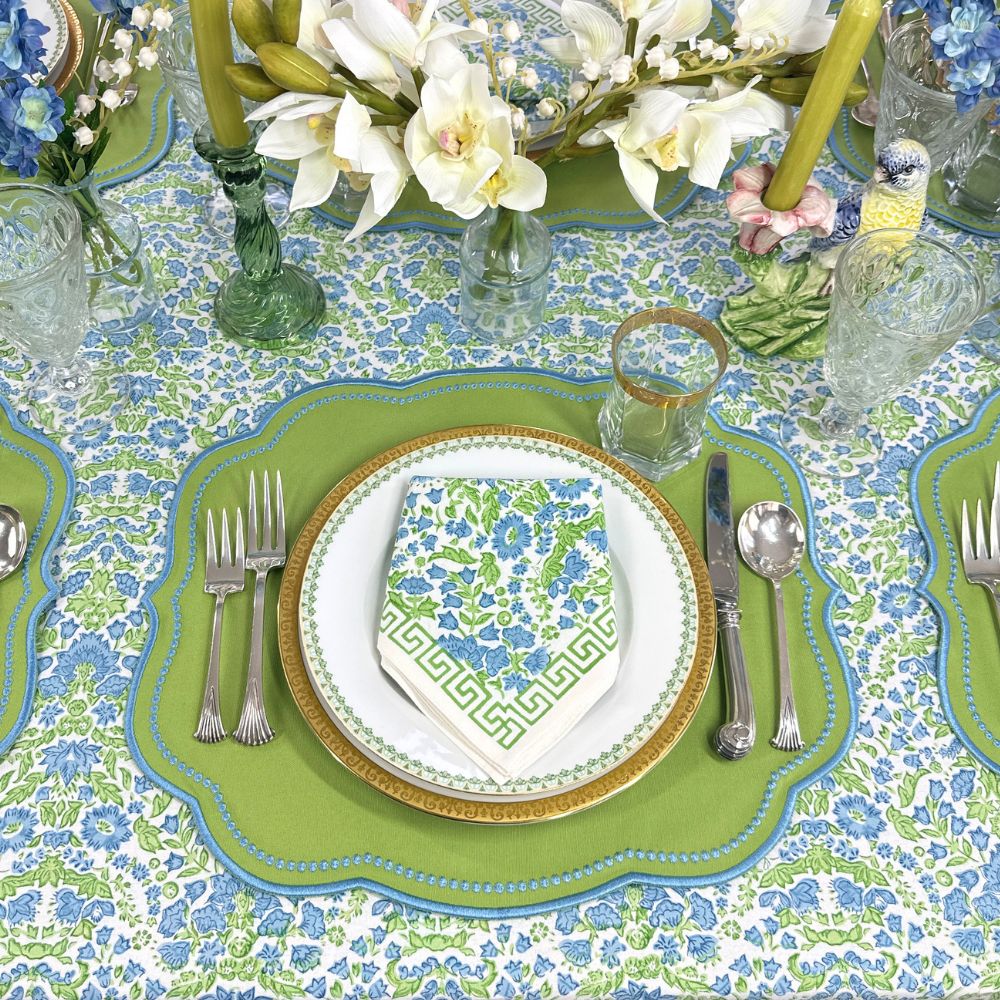 Elegant table setting with blue and green floral hand block printed tablecloth and matching napkin with greek key border and luxury embroidered placemat with decorations 