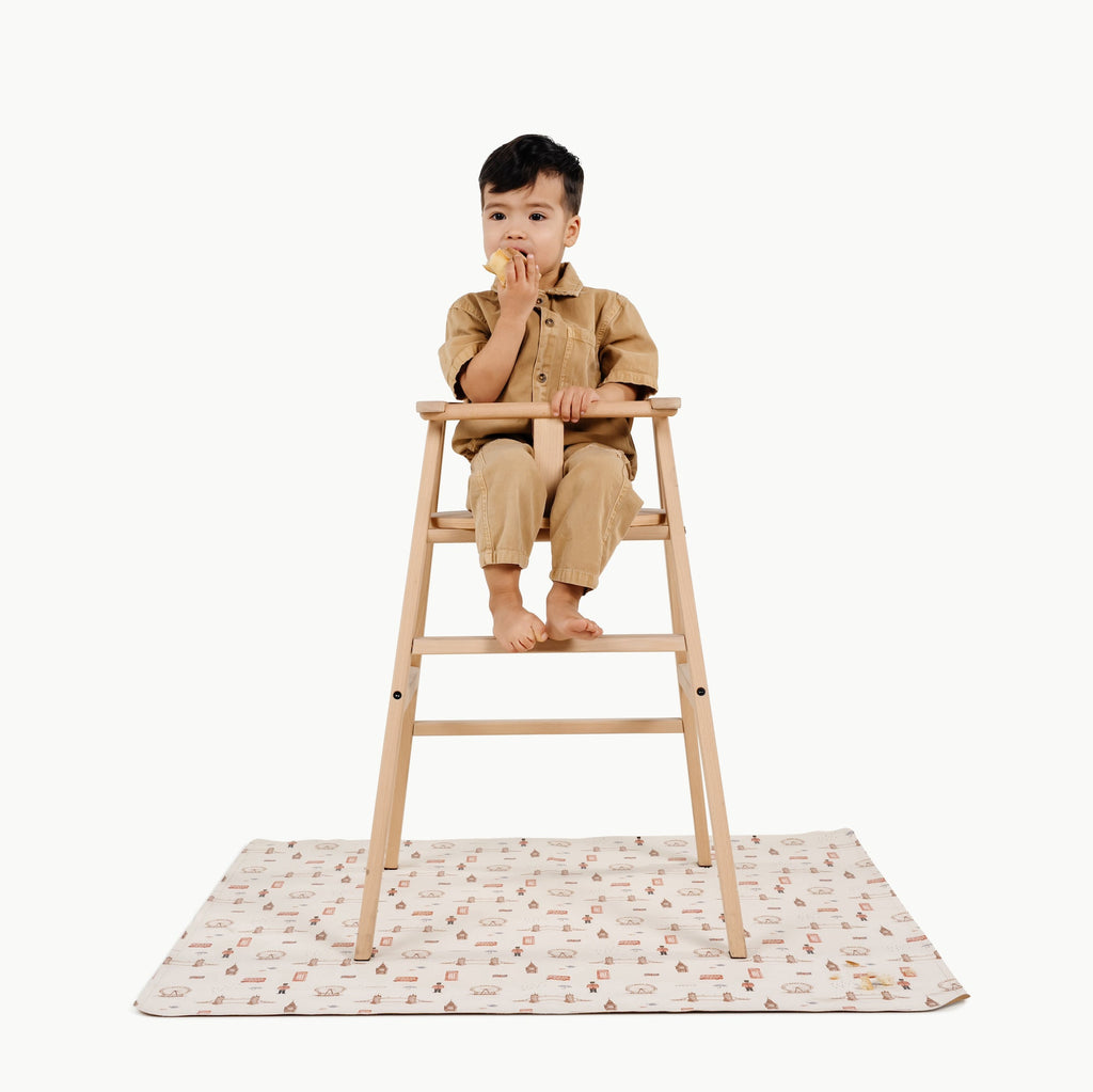 London@kid in a highchair on the london mini mat