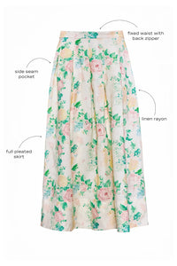 The Alexis Skirt in Garden Rose Peony paired with white Mare Top with blue background.