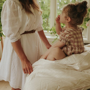 Petal Scallop Baby Duvet with child sitting on top with mother by side