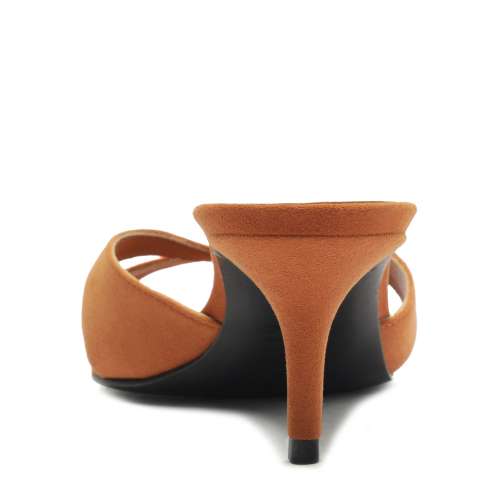Rear view of Hilda Leaf mule suede sandal in Cuoio brown showing the tapered covered heel and crisscross straps on white background
