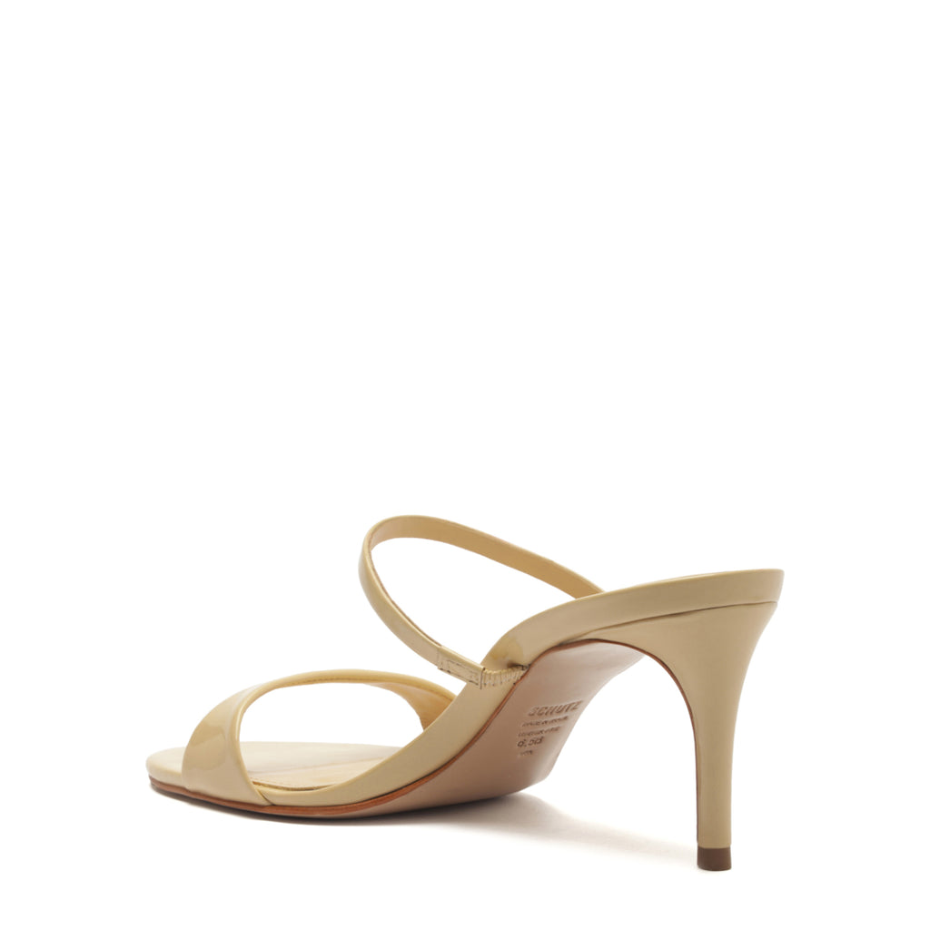 Side view of Jessica mid mule patent sandal in natural nibs showcasing slim double straps and 3-inch mid heel on white background
