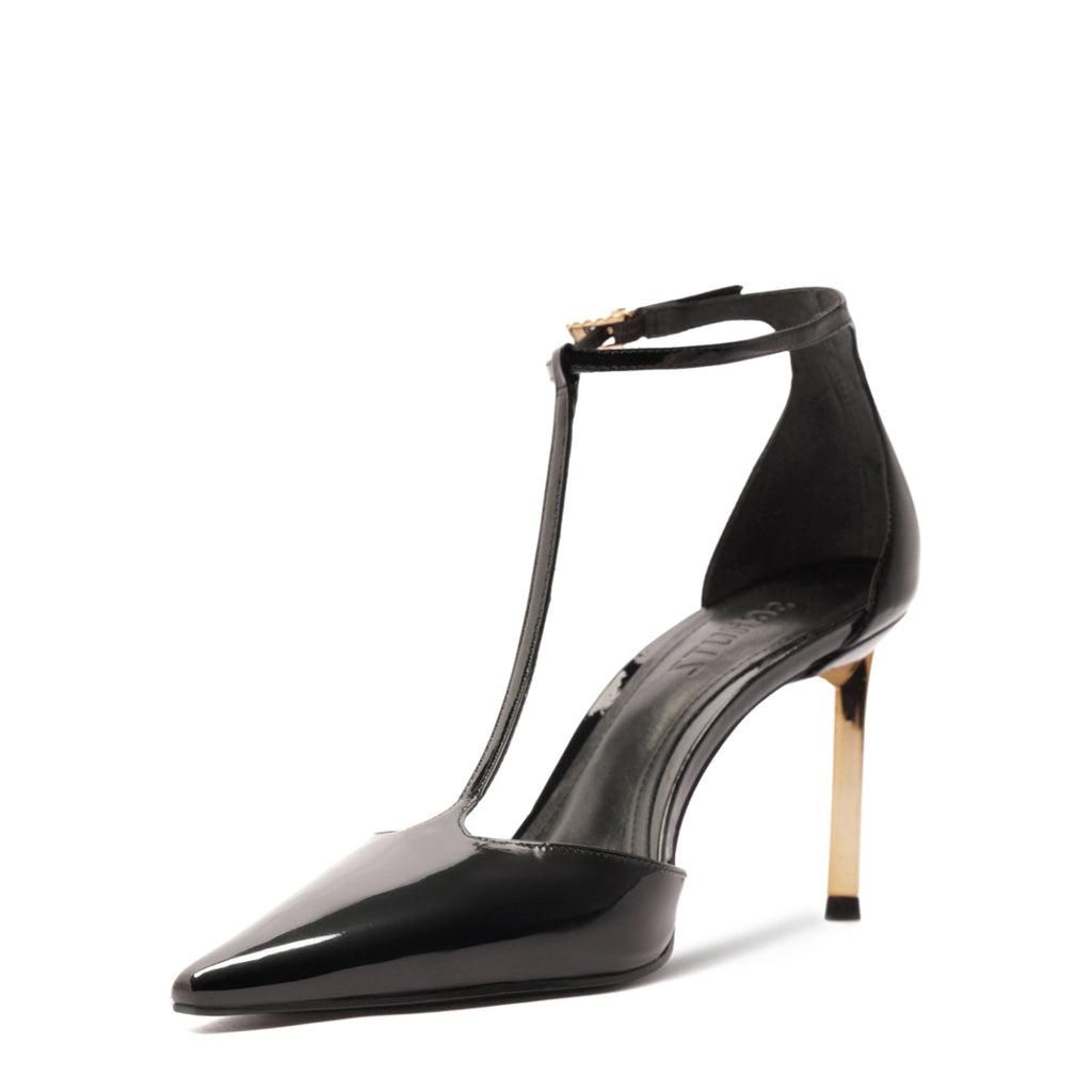 Three-quarter view of Allure T patent pump showing glossy black upper, pointed toe, T-strap, and gold stiletto heel on white background