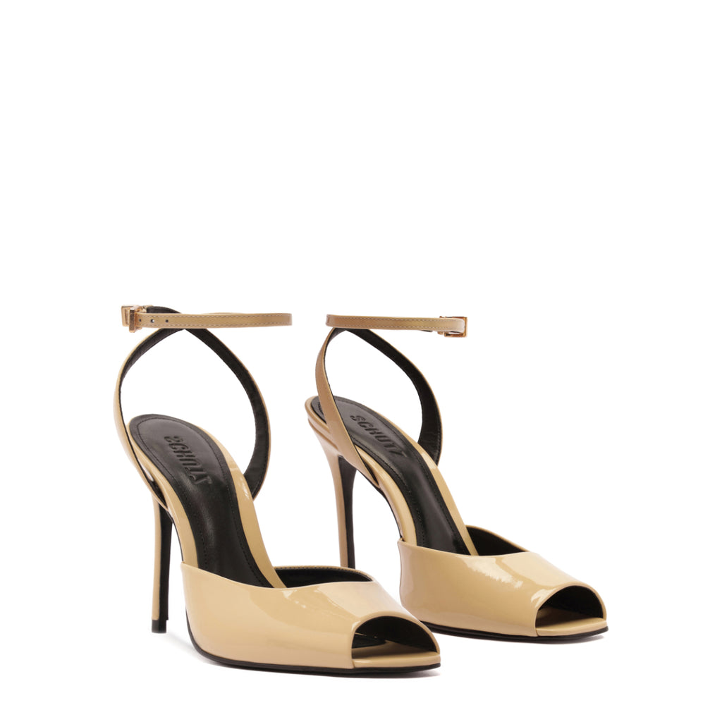 Three-quarter view of Estella patent pump in Natural Nibs with glossy peep toe, ankle strap and stiletto heel