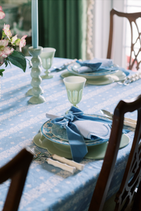 Close-up of blue dotted white linen napkin and placemat set of 2 showing scalloped edges on a styled table