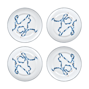 A set of four ribbon dinner plates in Blue. Comprised of a series of ribbon adorned plates, the collection is a delightful departure from traditional holiday decor. The plates are inspired by prints of citrus fruits from the 17th and early 18th centuries showing ribbons bearing the names of the depicted fruit.