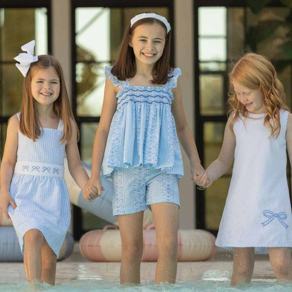 Girl wearing the Henry Duvall smocked shorts set in South Charles Stripe, a classic girls outfit designed for warm weather and family photos.