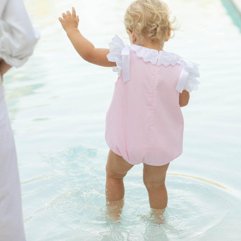 Toddler girl wearing the Henry Duvall Rosie Bubble, a classic pink bubble designed for spring days and special moments.
