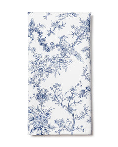 Folded front view of Signature Twill napkin showcasing navy blue toile bird and floral print on white background