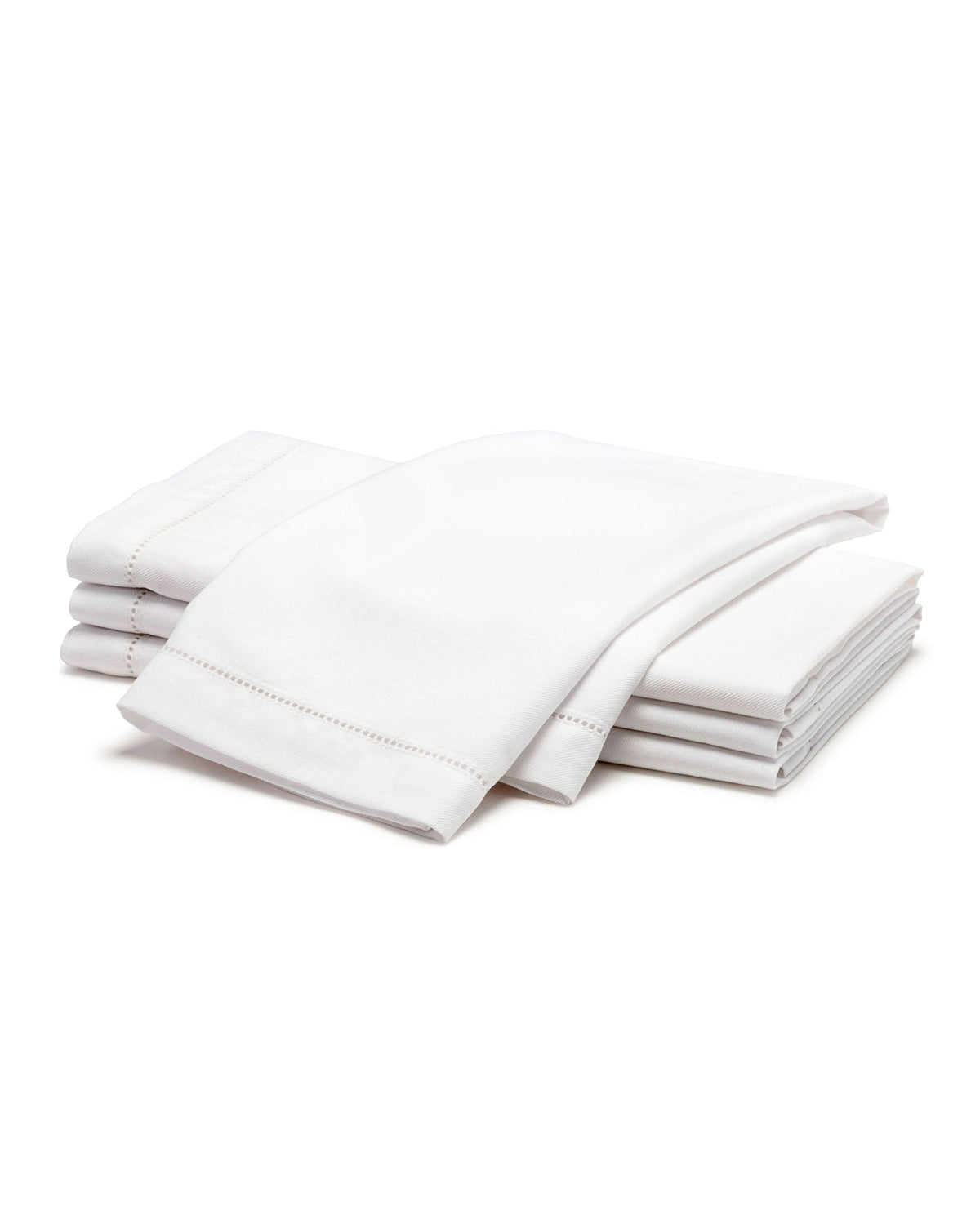 Stacked view of four folded white twill napkins showing hemstitch edge on white background