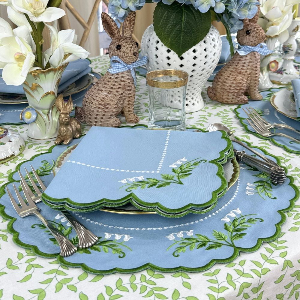 Easter-themed table setting with bunny decorations and floral centerpieces.
