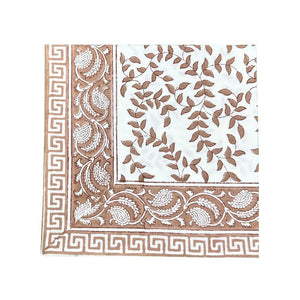 Decorative cloth napkin with brown and white leaves patterns on a white background
