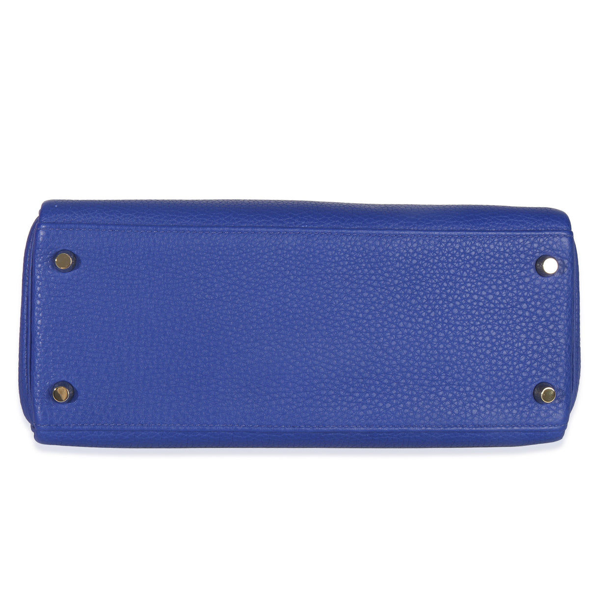 Bottom view of Hermès Kelly 28 Bleu Electrique Togo leather showing four gold feet on white background