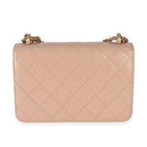 Back of Chanel Mini Perfect Fit Flap Bag showing beige quilted calfskin and gold tone chain strap on white background