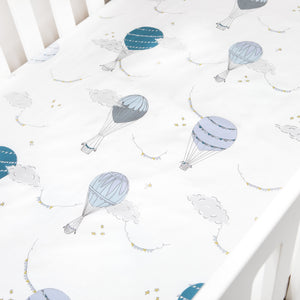 Crib Sheet in "Touch The Sky" print in the color blue featured in a crib