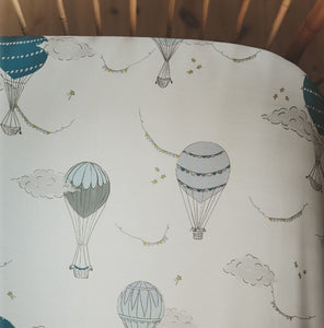 Crib Sheet in "Touch The Sky" print in the color blue featured in a crib