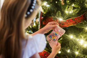 Christmas tree decorated with Bauble Stockings, shimmering ornaments, and twinkling lights