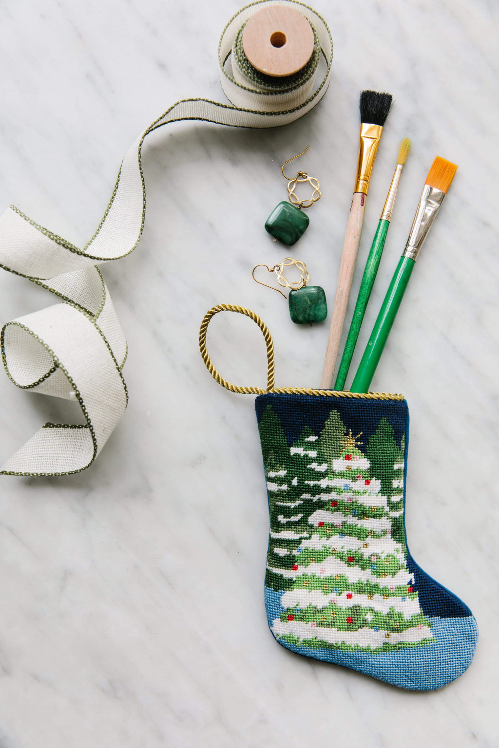 Bauble Stockings with paintbrushes on marble background for a wintry setting