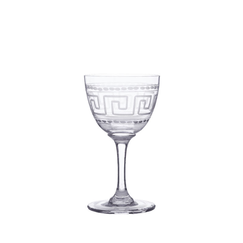 Front view of crystal liqueur glass showcasing engraved Greek key band and dotted border on white background