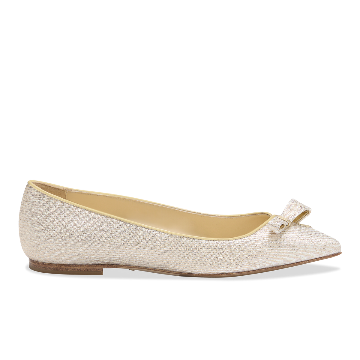 Side view of Natalie flat in champagne lame showcasing pointed toe, bow detail, low heel on white background