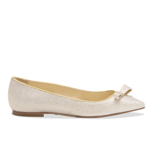 Side view of Natalie flat in champagne lame showcasing pointed toe, bow detail, low heel on white background