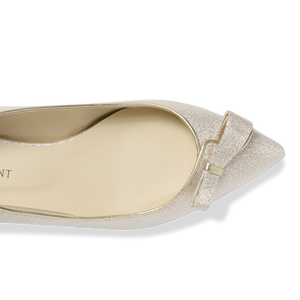 Top view of Natalie pointed-toe flat in champagne lame showing bow detail and metallic shimmer on black background