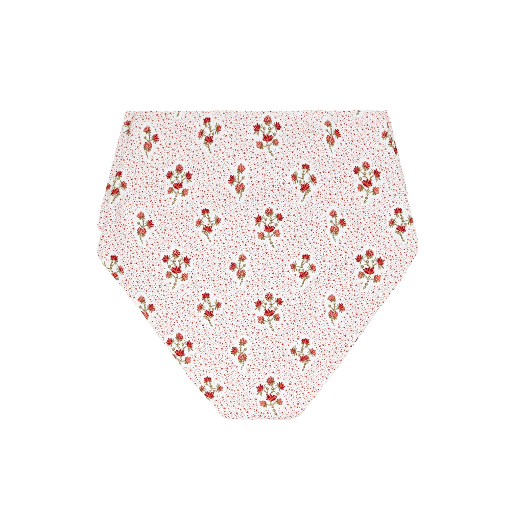 Flat lay of women’s high-waist bikini bottom showing white fabric with small raspberry-red floral print on white background